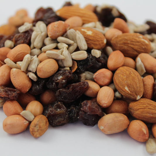 Assorted nuts and seeds on a white background