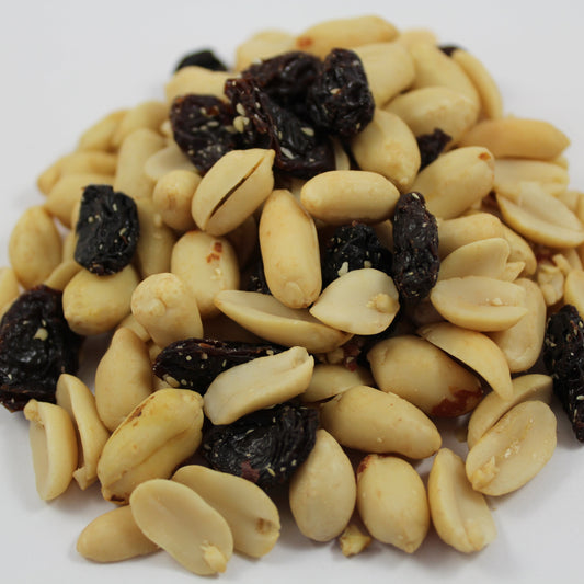 Pile of peanuts and raisins on a white background