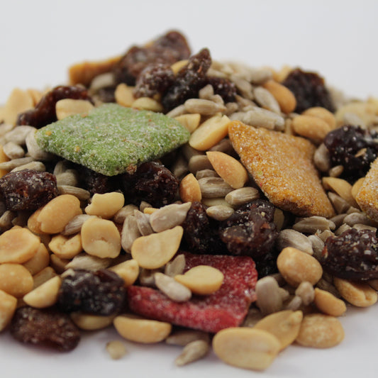 Assorted trail mix with nuts, seeds, and dried fruits on a white background